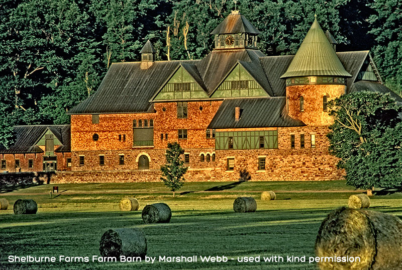 A large, European looking structure made of stone and wood that looks like a castle but is really a barn.